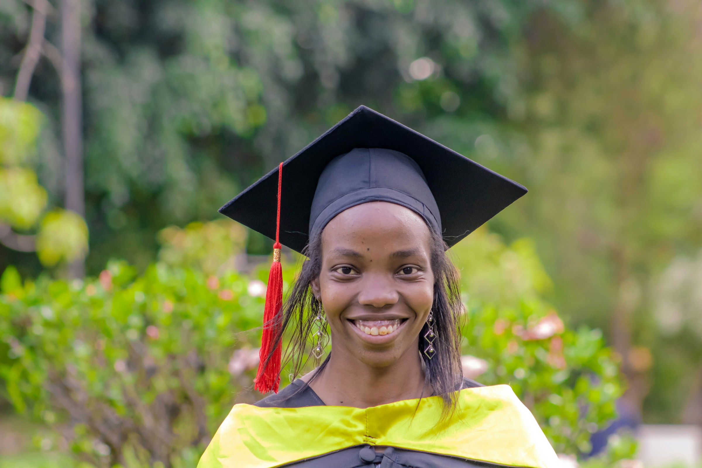 A happy graduate in their cap and gown, used as a folder cover for graduation memories.